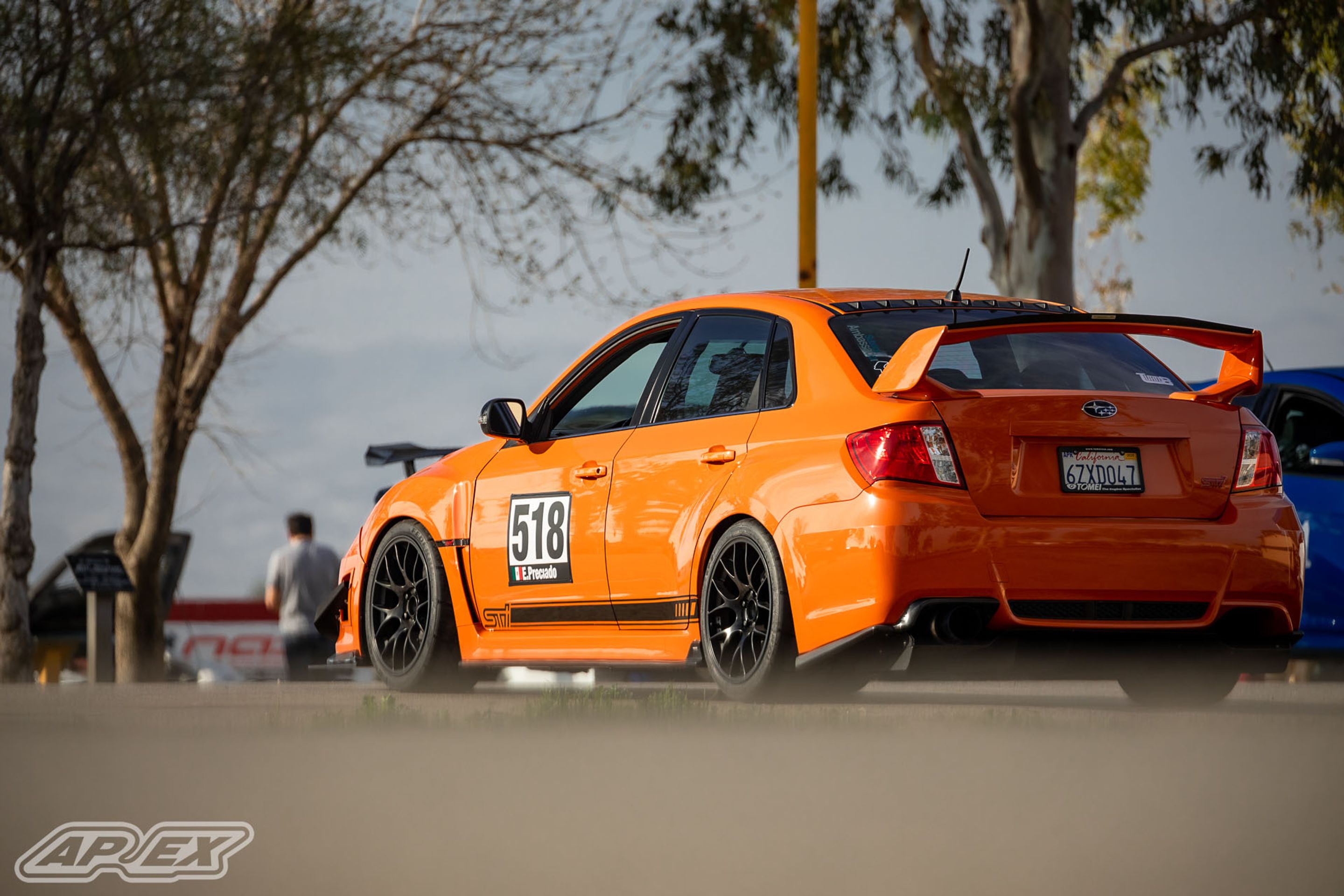 Orange Subaru GR WRX STI with 18" EC-7 Apex wheels in Satin Black