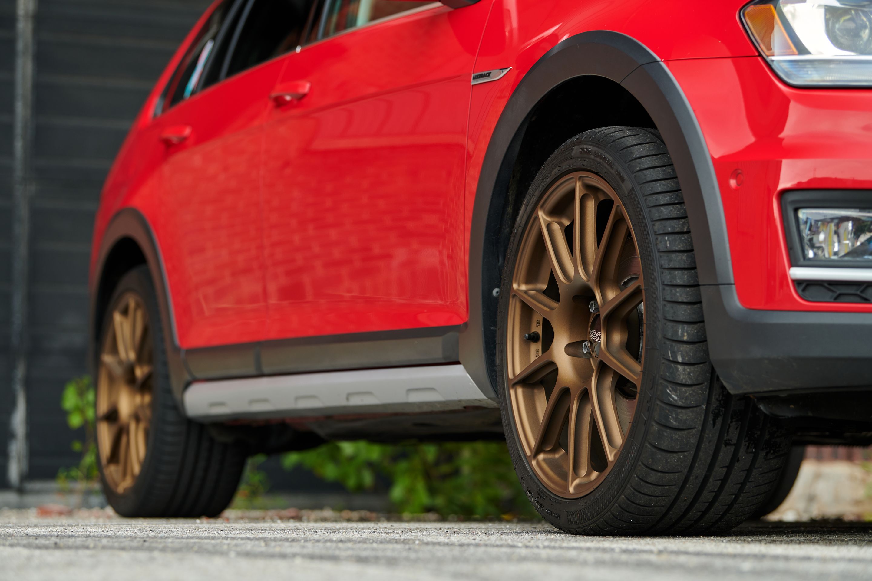 Red VW MK7 Alltrack/SportWagen Alltrack with 18" SM-10 Apex wheels in Satin Bronze