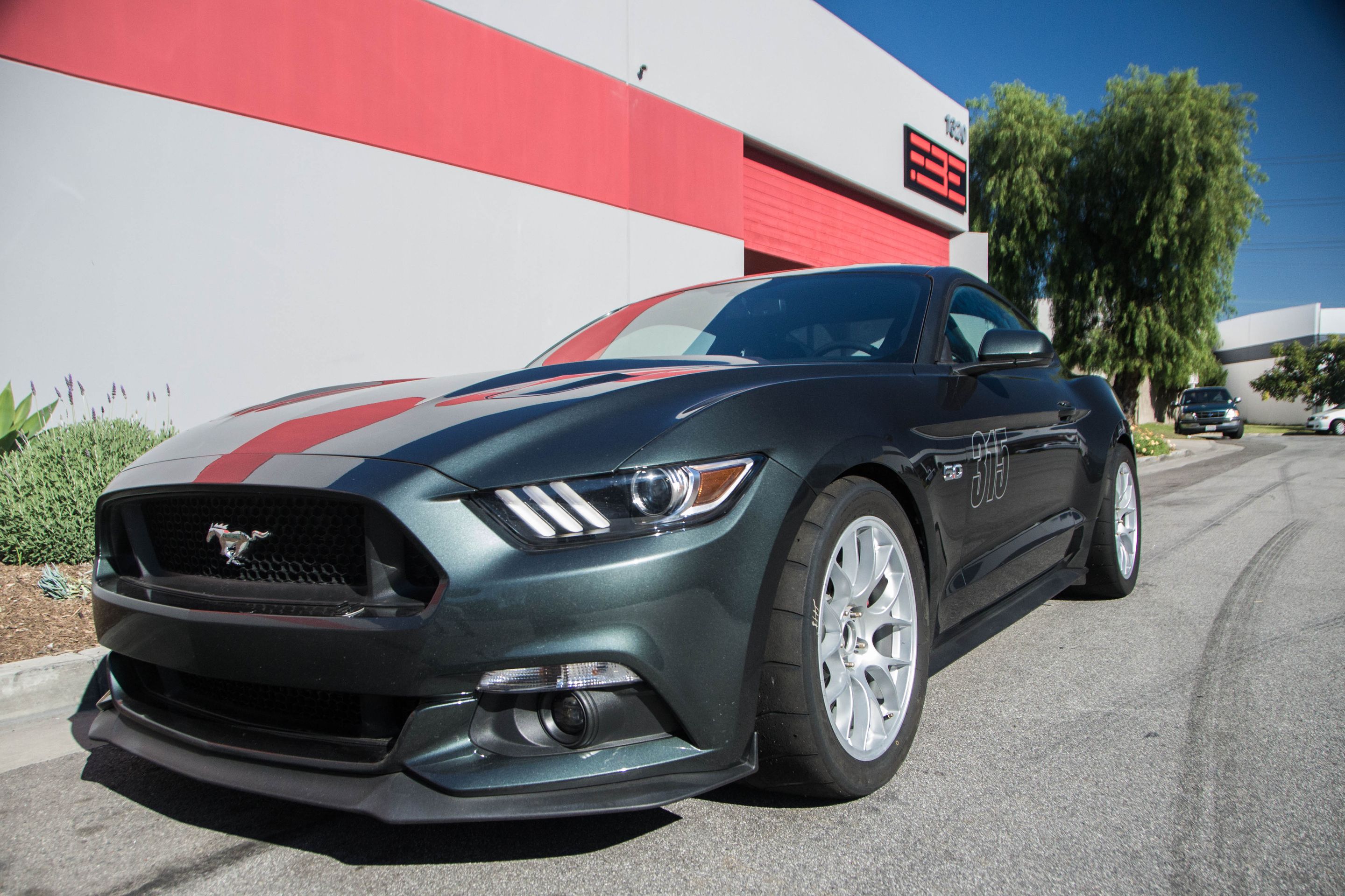 Green Ford S550 Mustang GT with 18" EC-7 Apex wheels in Race Silver