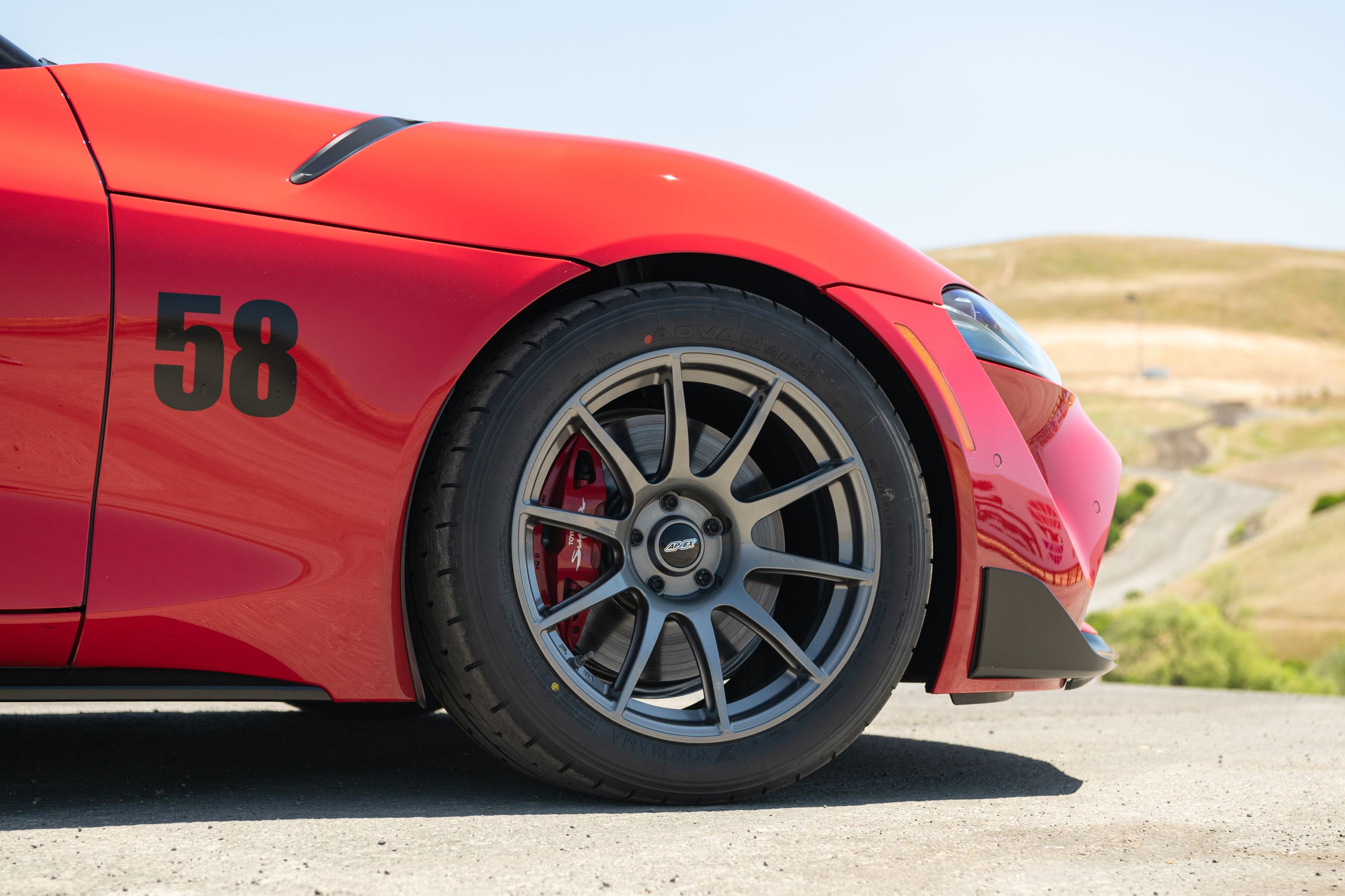 Red Toyota GR Supra with 18" SM-10 Apex wheels in Anthracite
