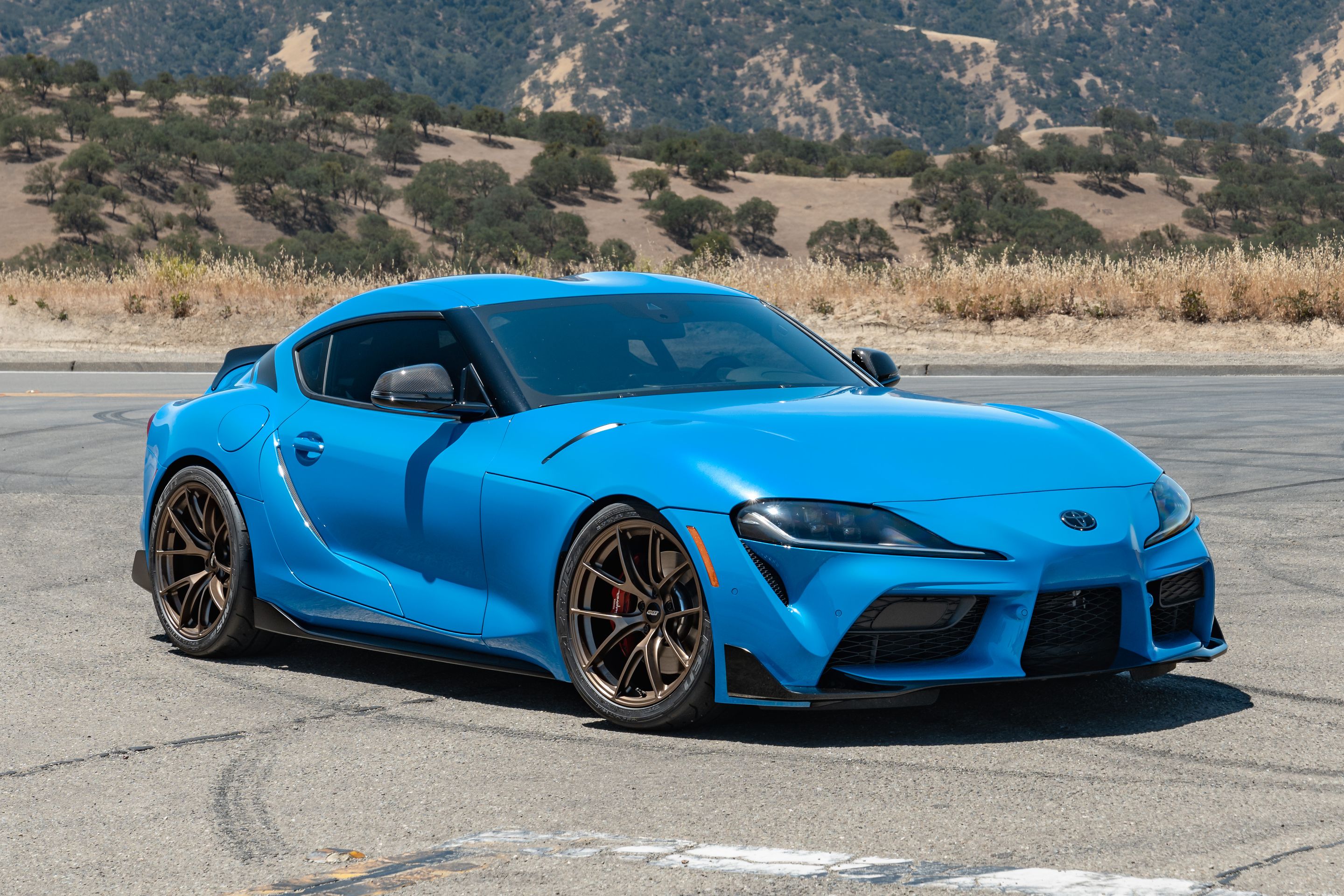 Blue Toyota GR Supra with 19" VS-5RS Apex wheels in Satin Bronze