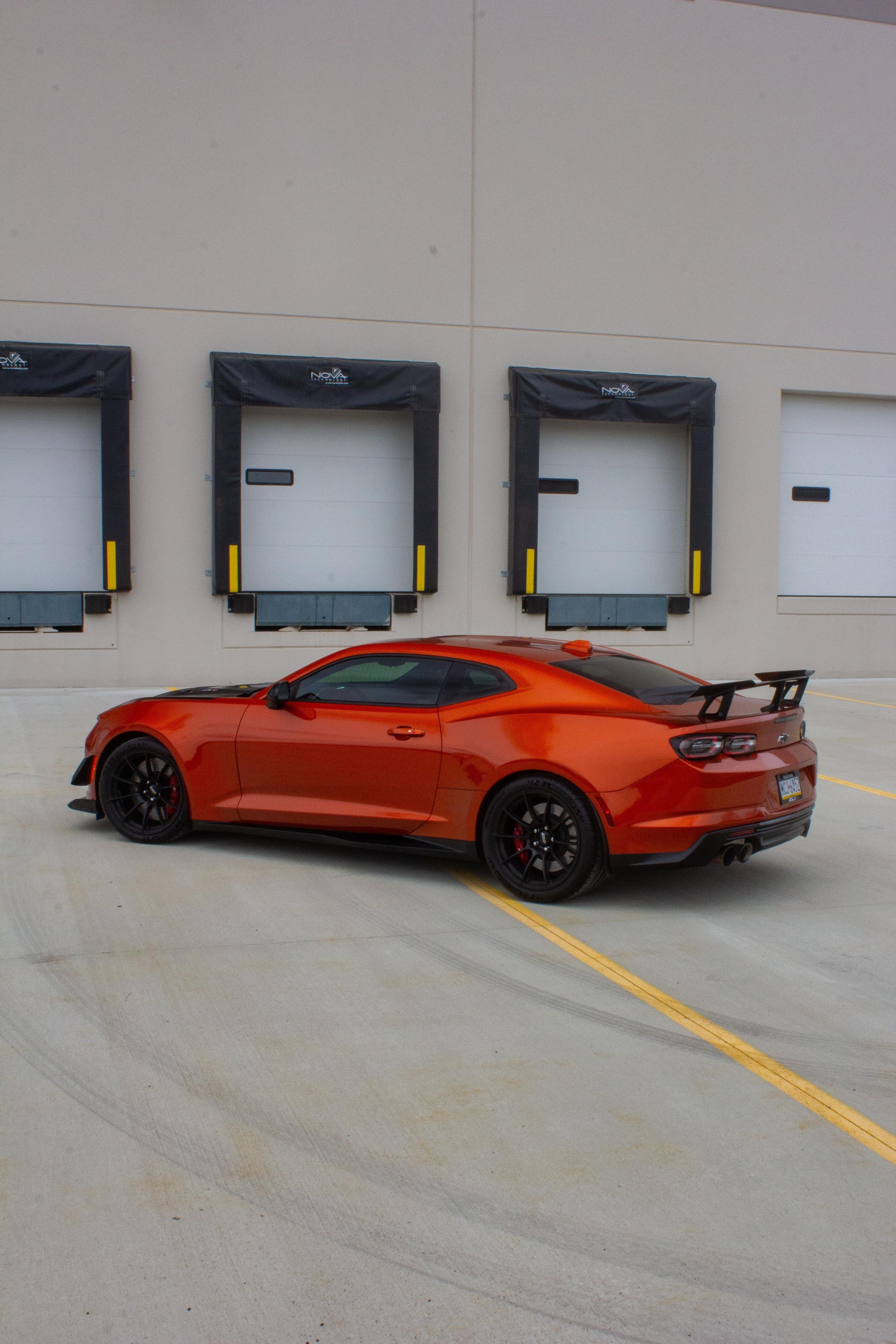 Red Chevrolet 6th Gen Camaro ZL1 1LE with 19" SM-10RS Apex wheels in Satin Black
