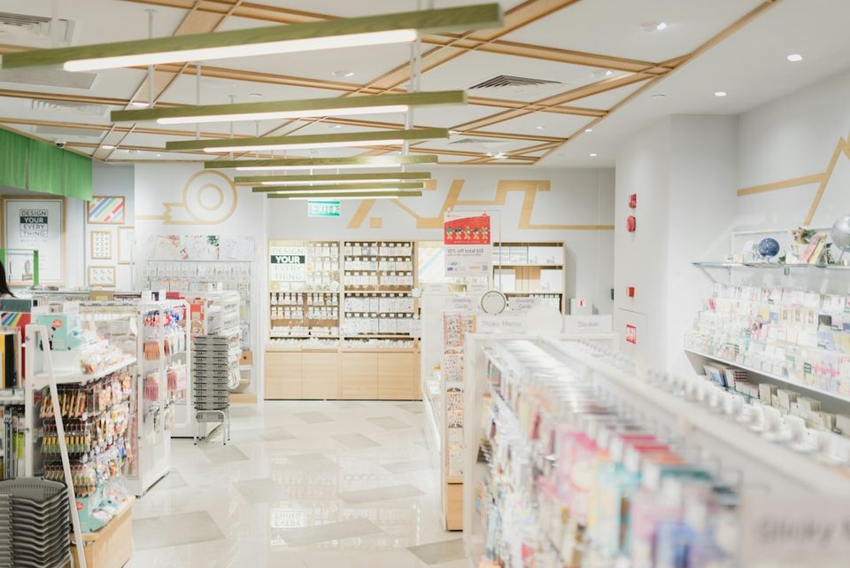 A bright stationery store interior with shelves of greeting cards and office supplies