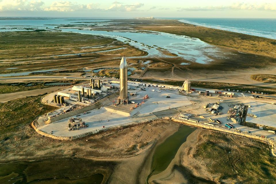 Rocket launchpad with a tall rocket and surrounding structures
