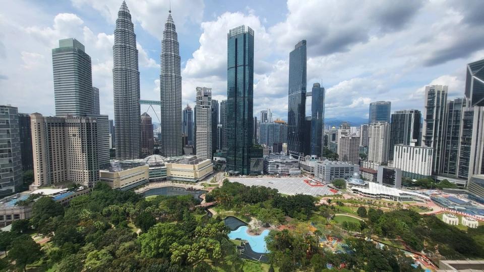 Elevated view of KLCC Park with the Petronas Twin Towers and surrounding skyscrapers of Kuala Lumpur City Centre.