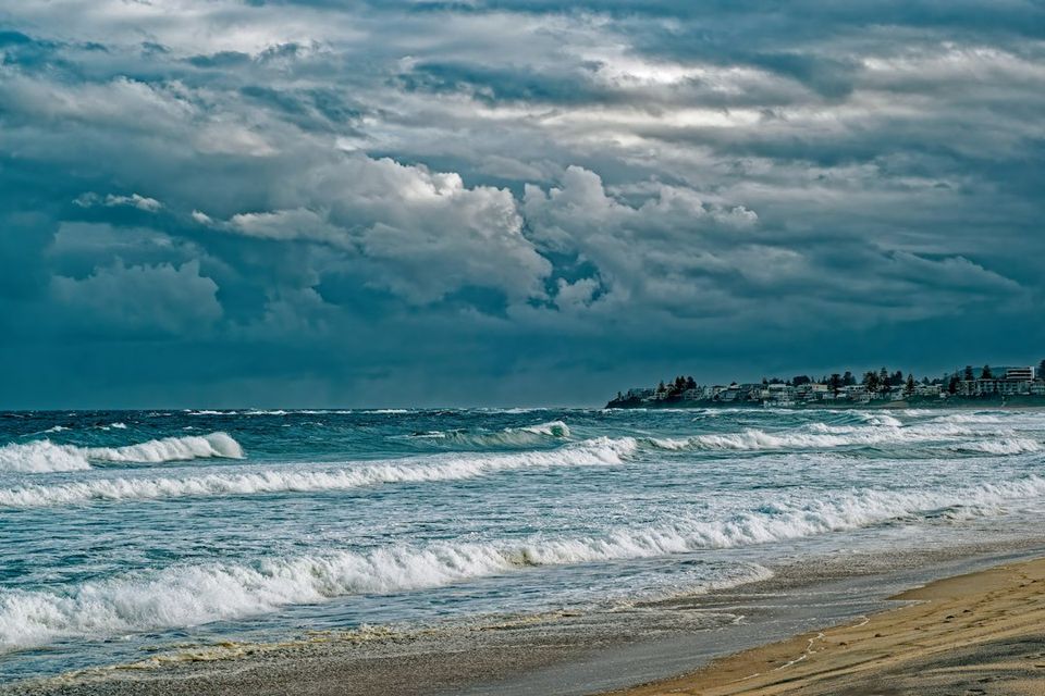 Stormy clouds over a turbulent ocean with waves crashing