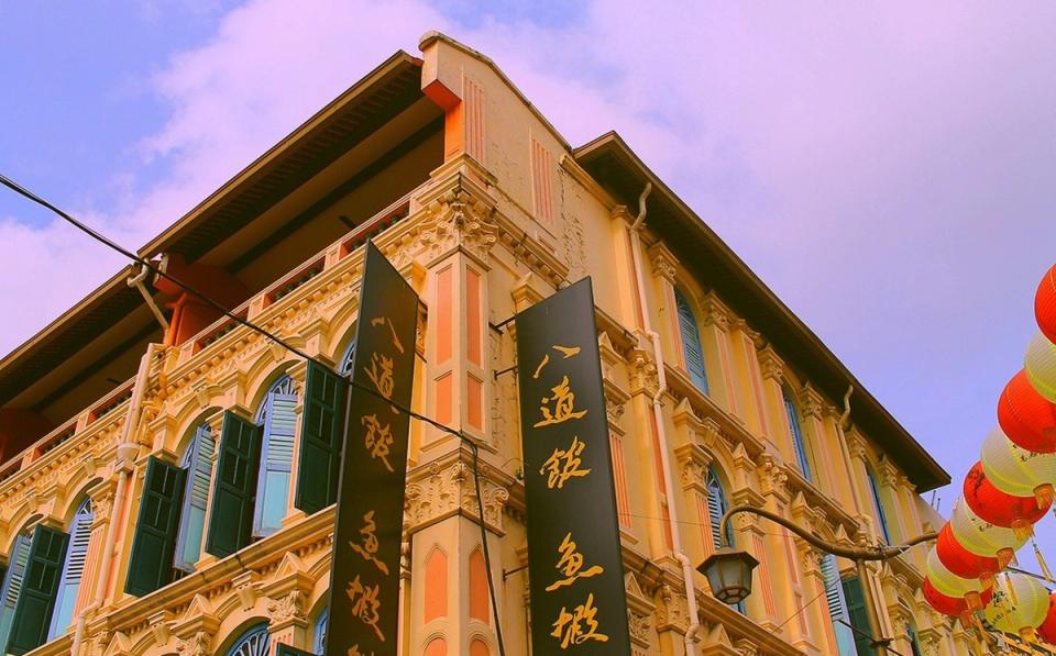 The exterior of a Chinese restaurant on a Chinatown street in Singapore.