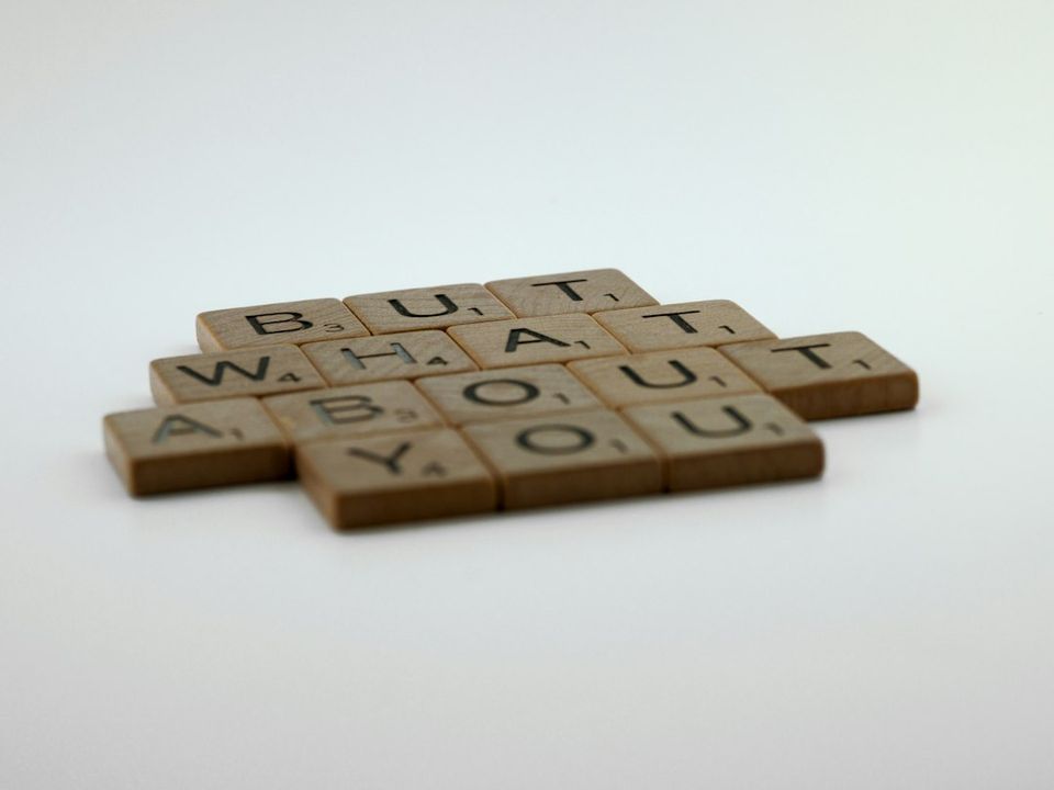 three scrabble tiles with words written on them
