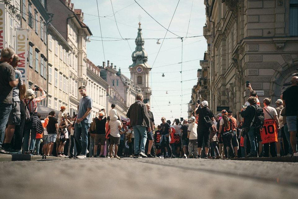 Crowd of people walking down a european street
