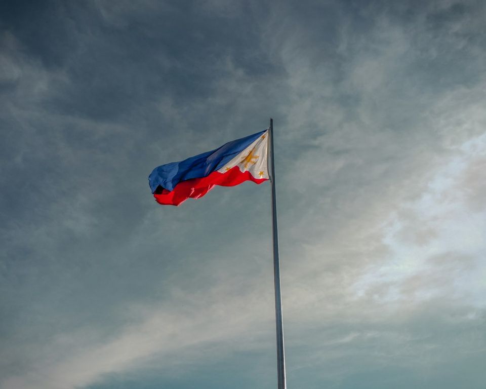 a flag flying in the wind on a cloudy day