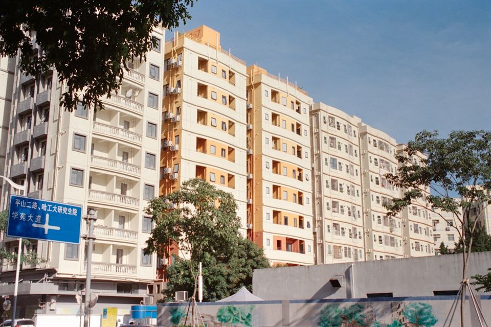 Apartment buildings stand tall under a bright sky