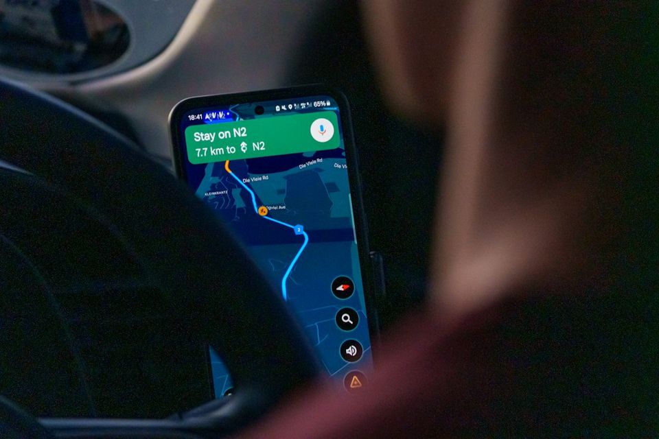 Person using navigation app on smartphone inside car