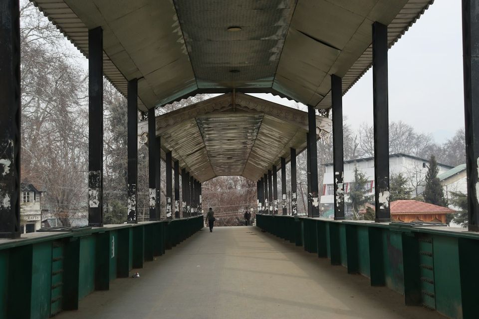 Covered pedestrian bridge with people walking