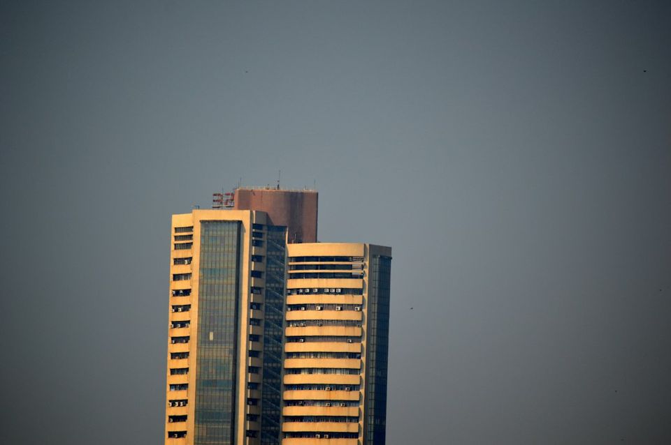 A modern high-rise building stands tall against a clear sky