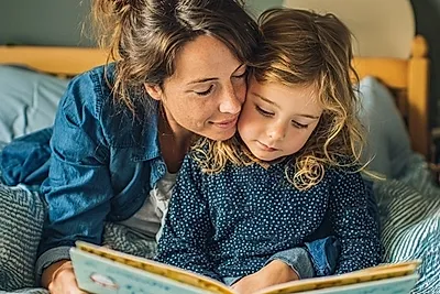mother and child reading a book together