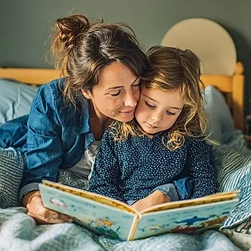 mother and child reading a book together