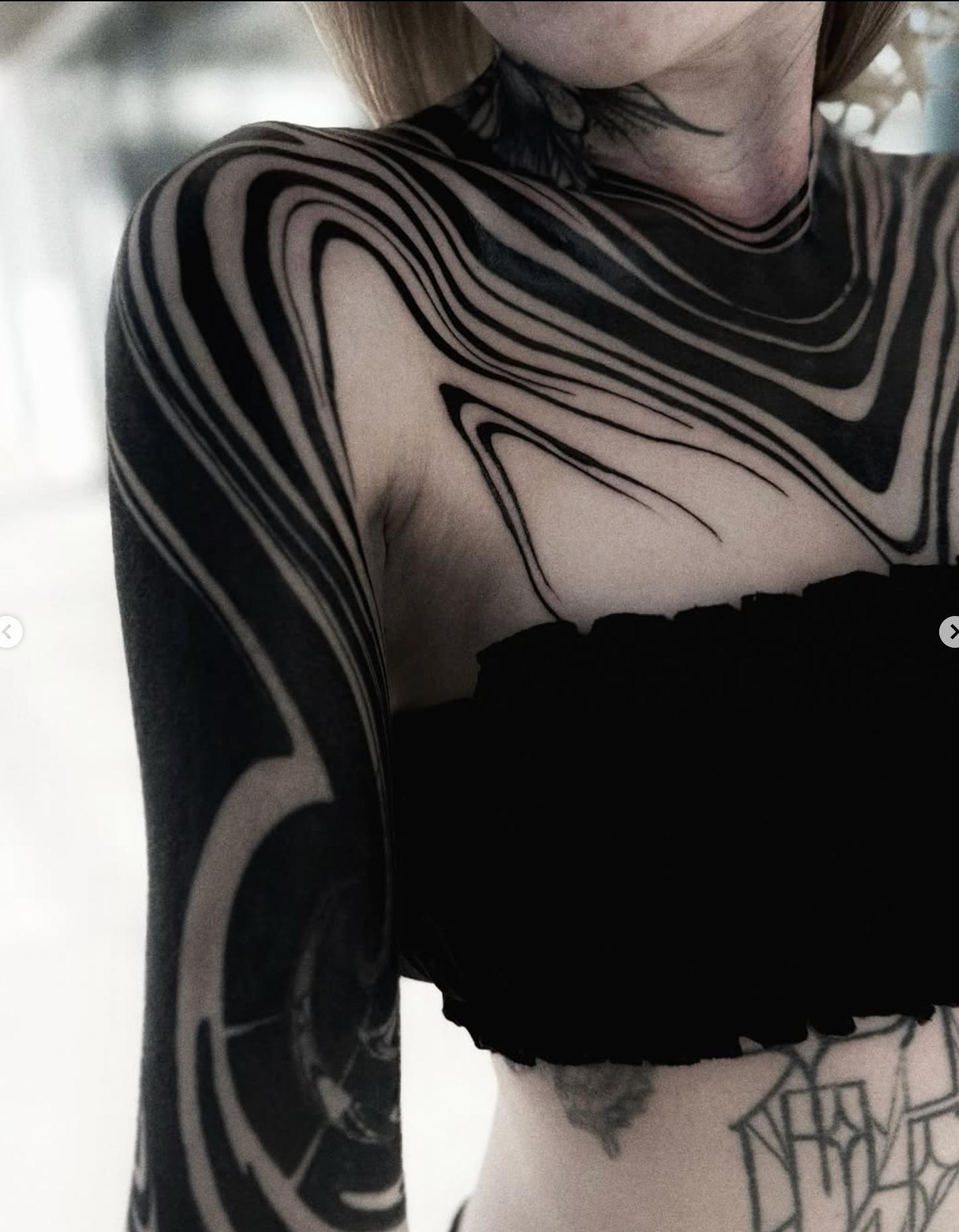 Blackwork abstract full sleeve tattoo on arm and shoulder