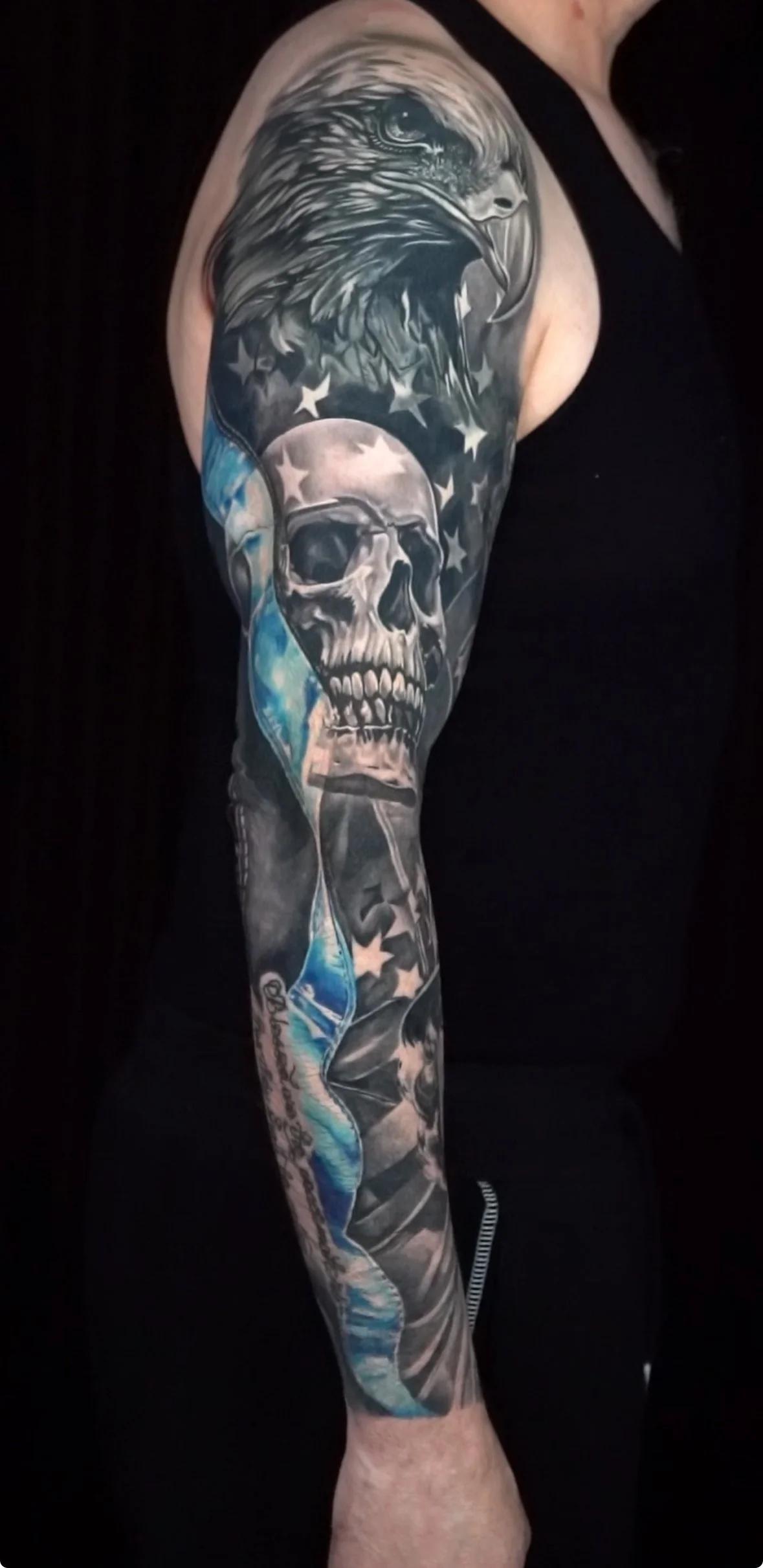 Realistic black and grey eagle and skull full sleeve tattoo with blue accents