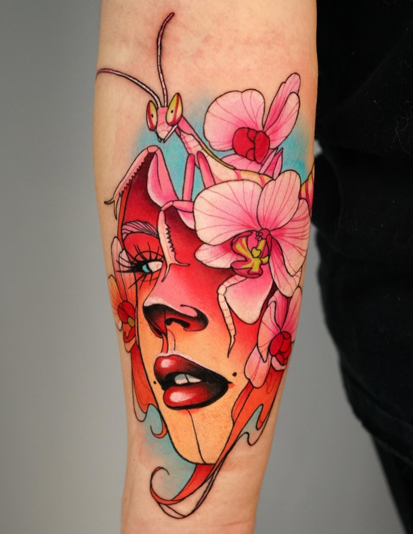 Colorful new school tattoo of a face, mantis, and flowers on forearm