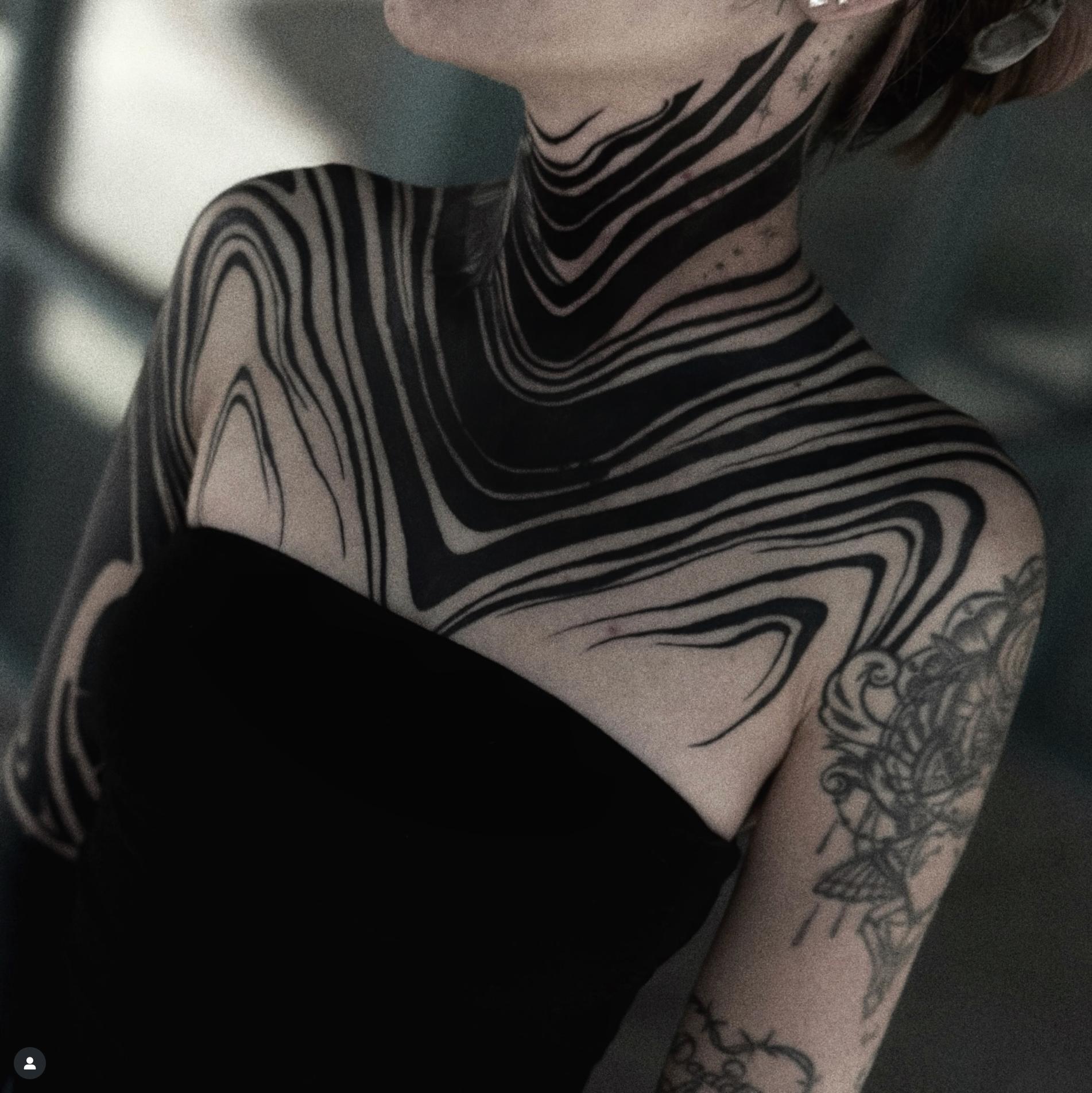 Blackwork abstract pattern tattoo on neck and shoulders