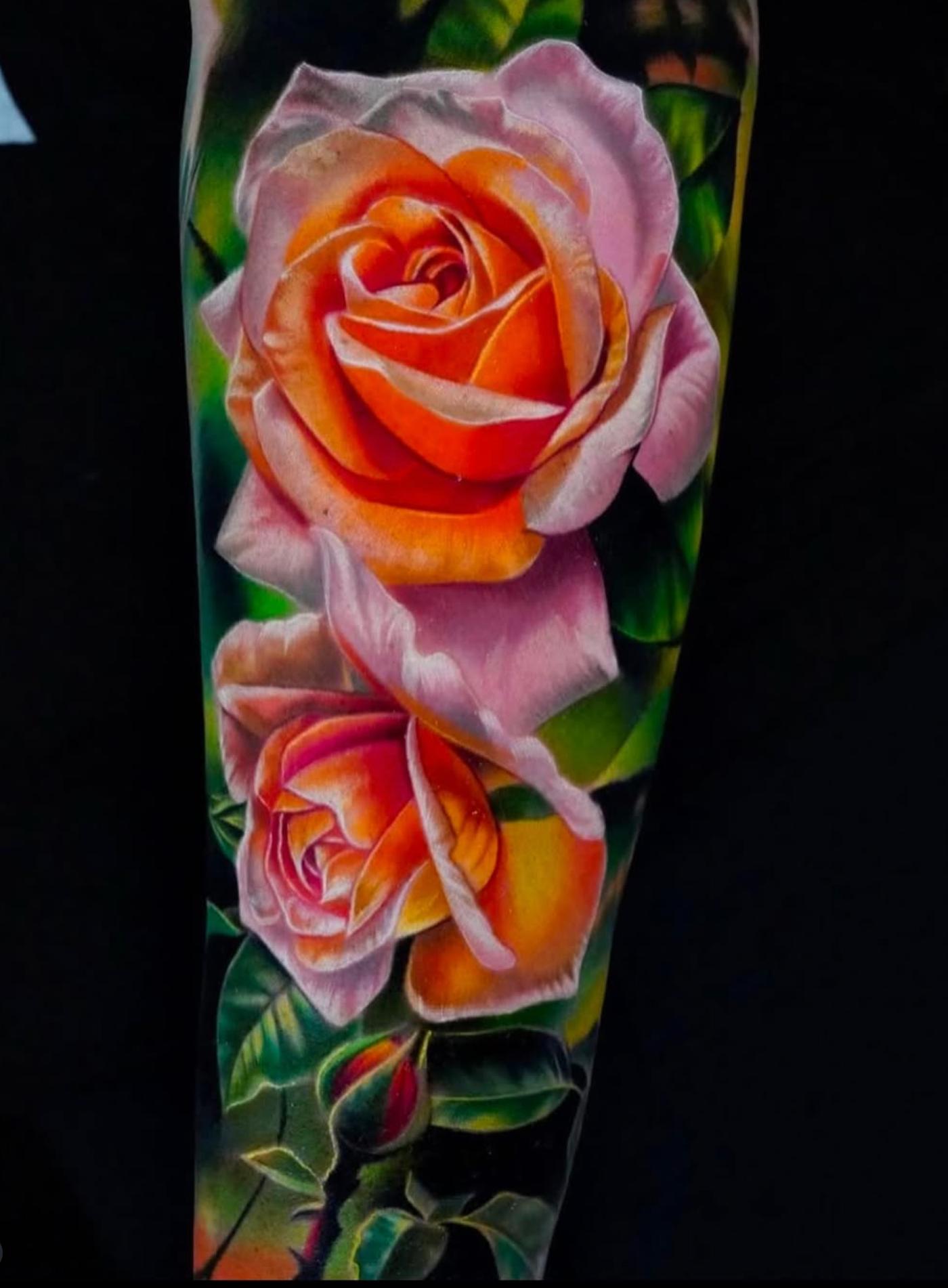 Colorful realistic rose tattoo on forearm