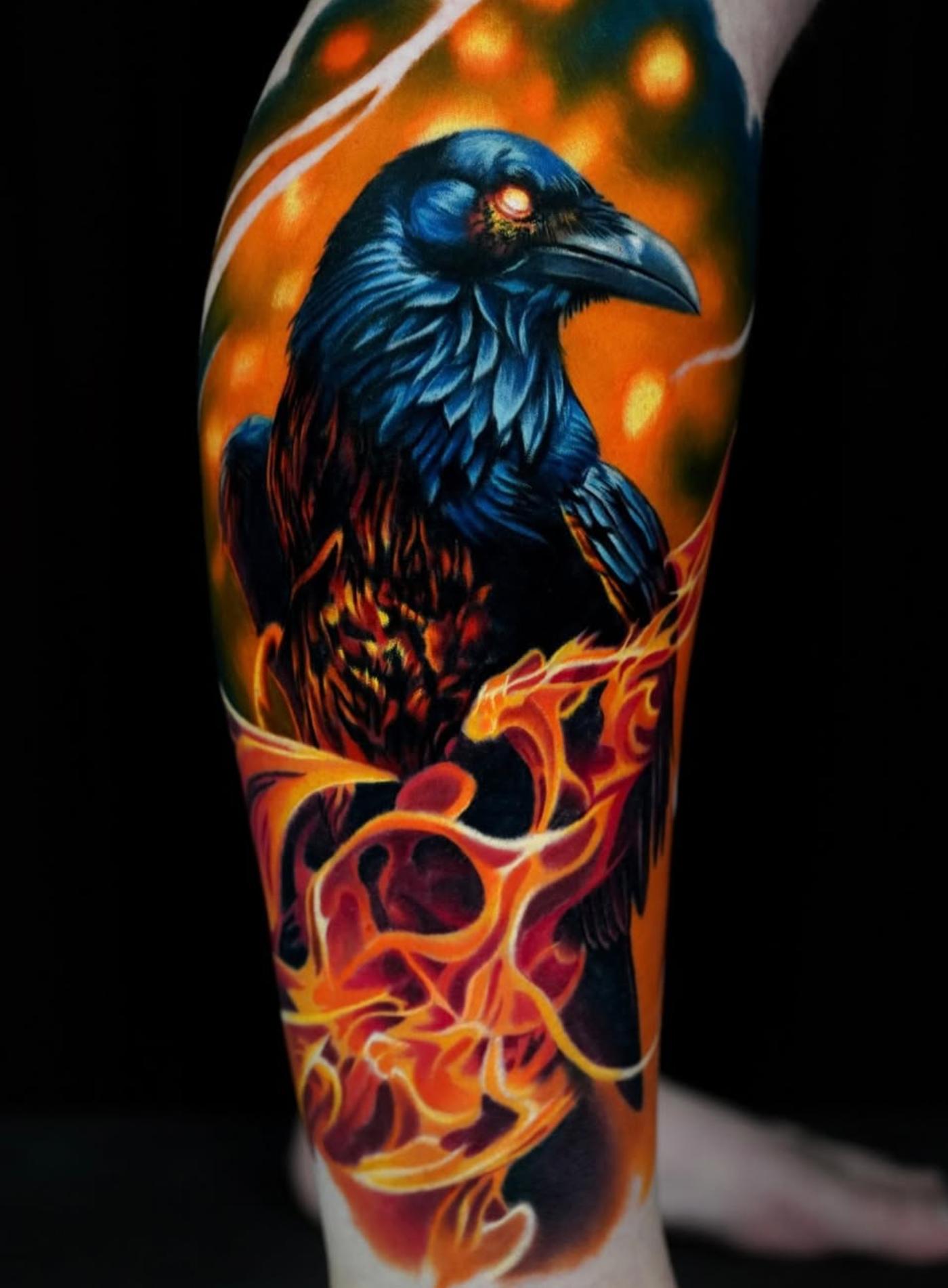 Colorful raven tattoo with flames on calf