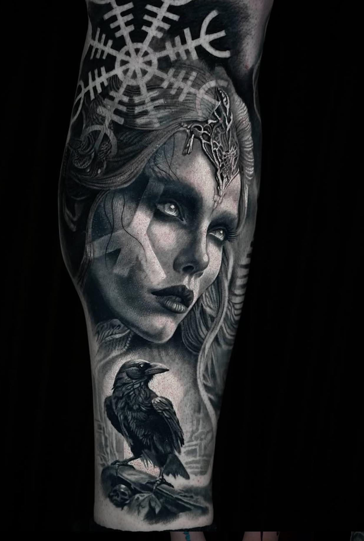 Black and grey realistic Norse woman and raven on forearm
