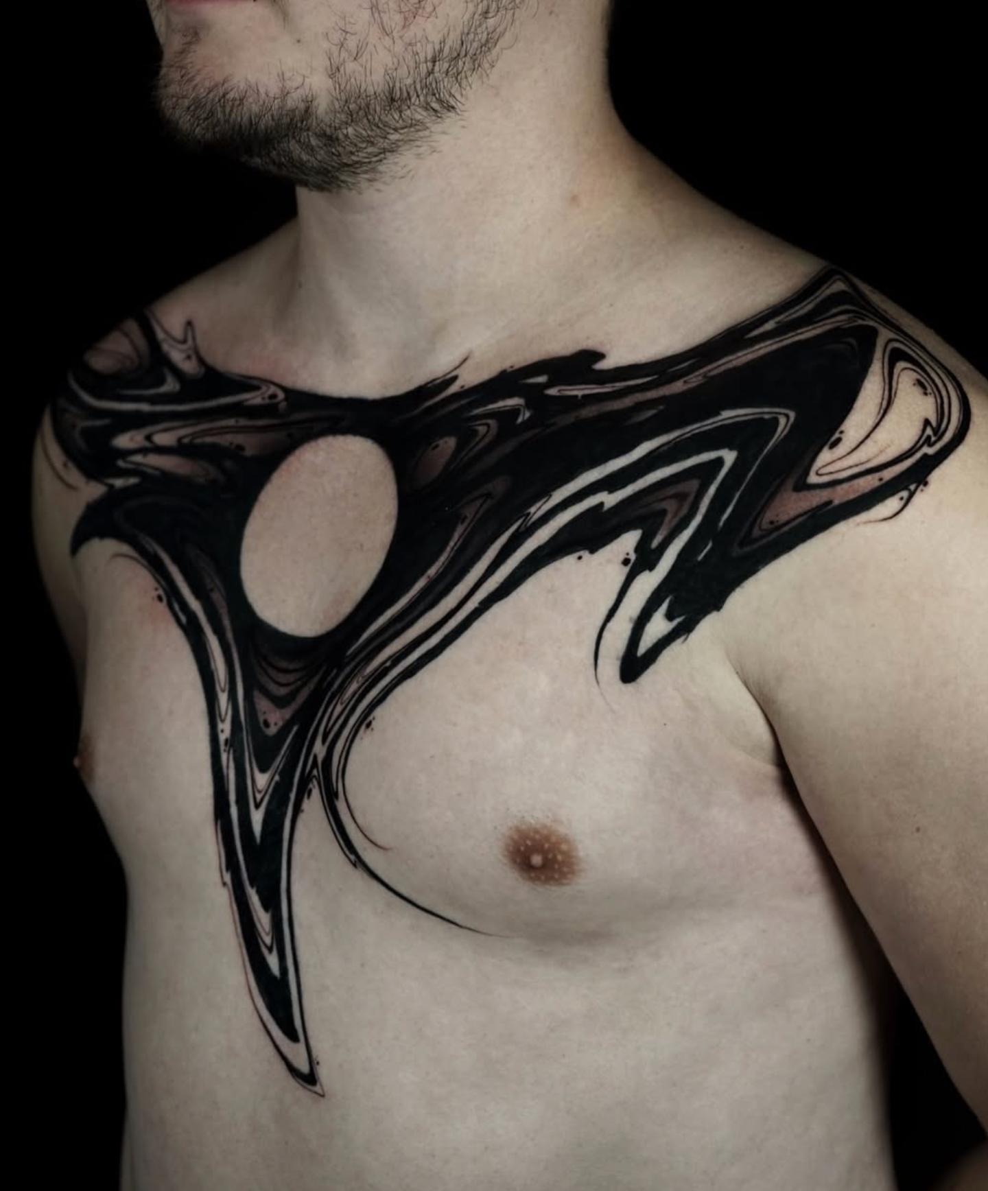 Abstract blackwork swirl tattoo on chest
