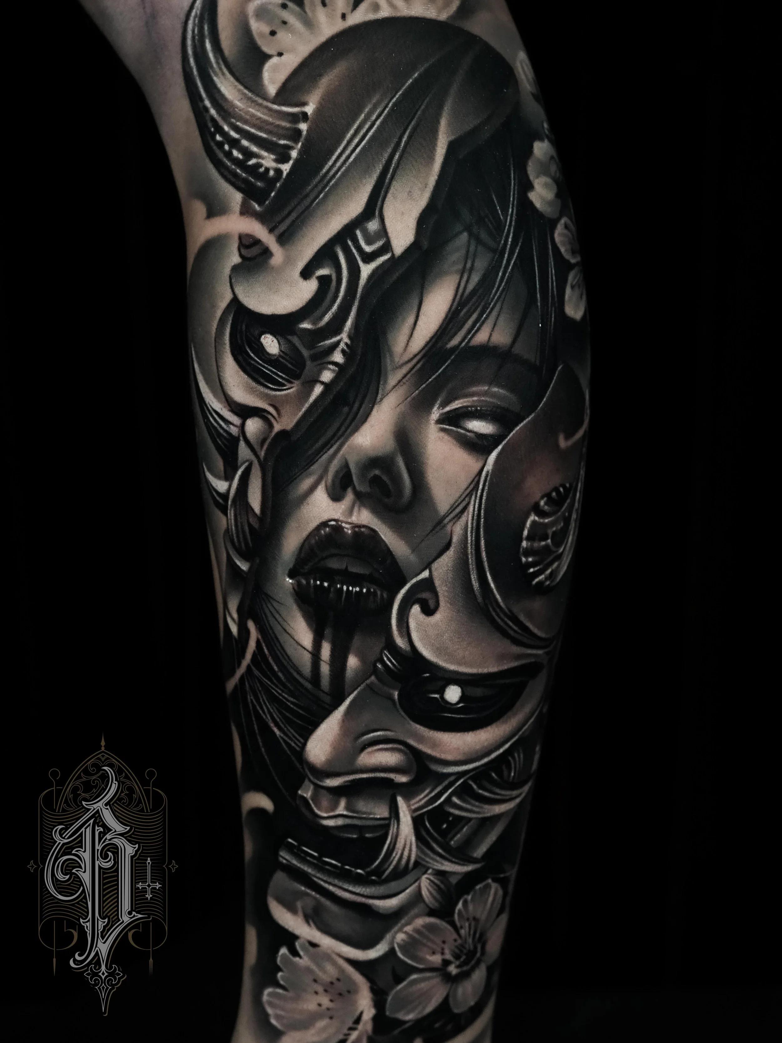 Black and grey realistic Japanese mask and face tattoo on upper arm