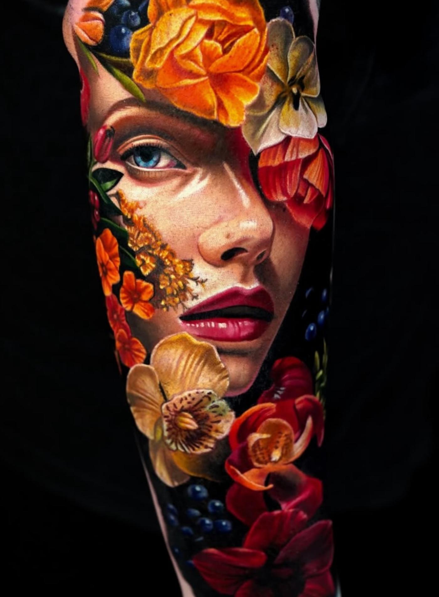 Colorful realistic floral portrait tattoo on forearm
