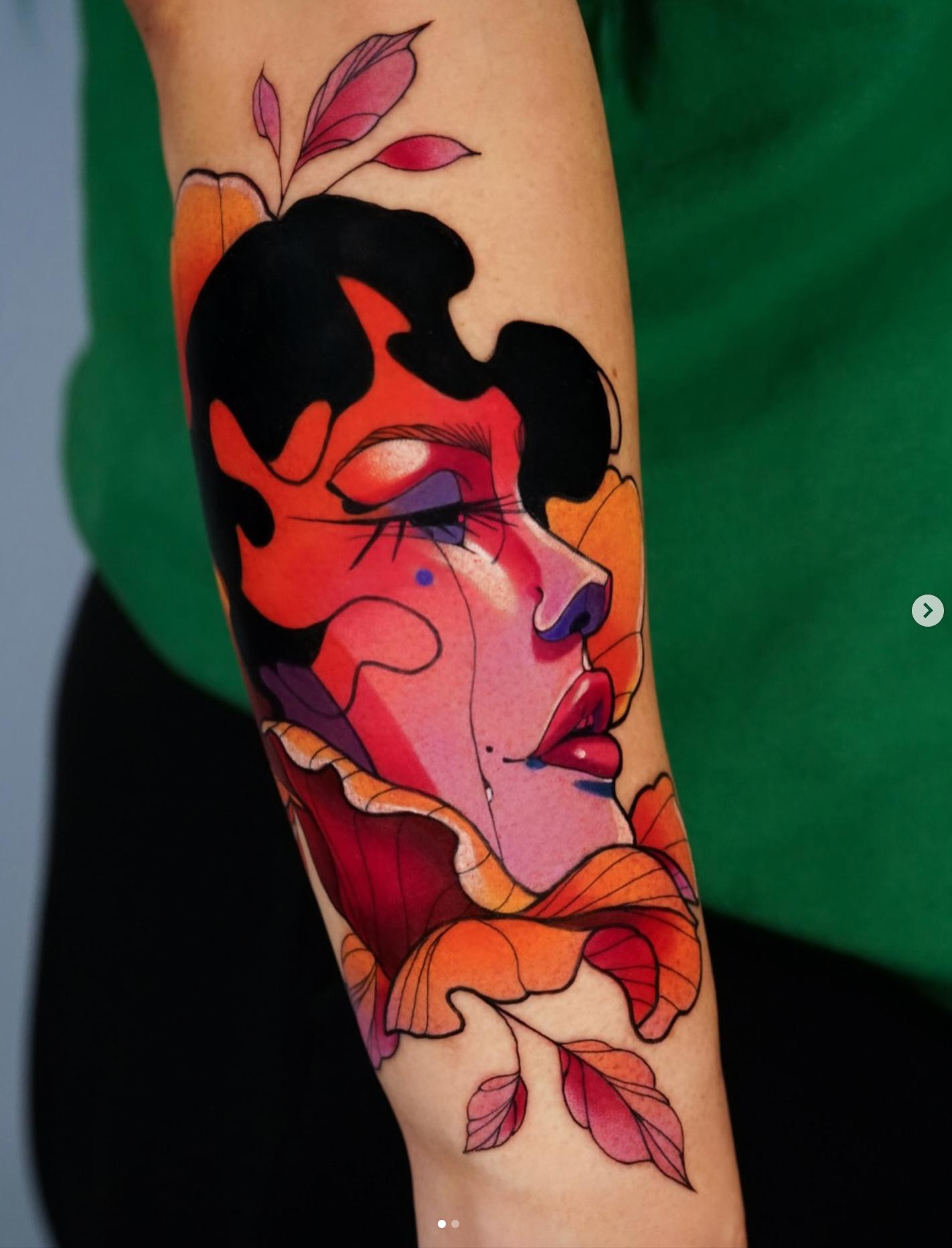 Colorful illustrative tattoo of a woman's face with floral motifs on forearm