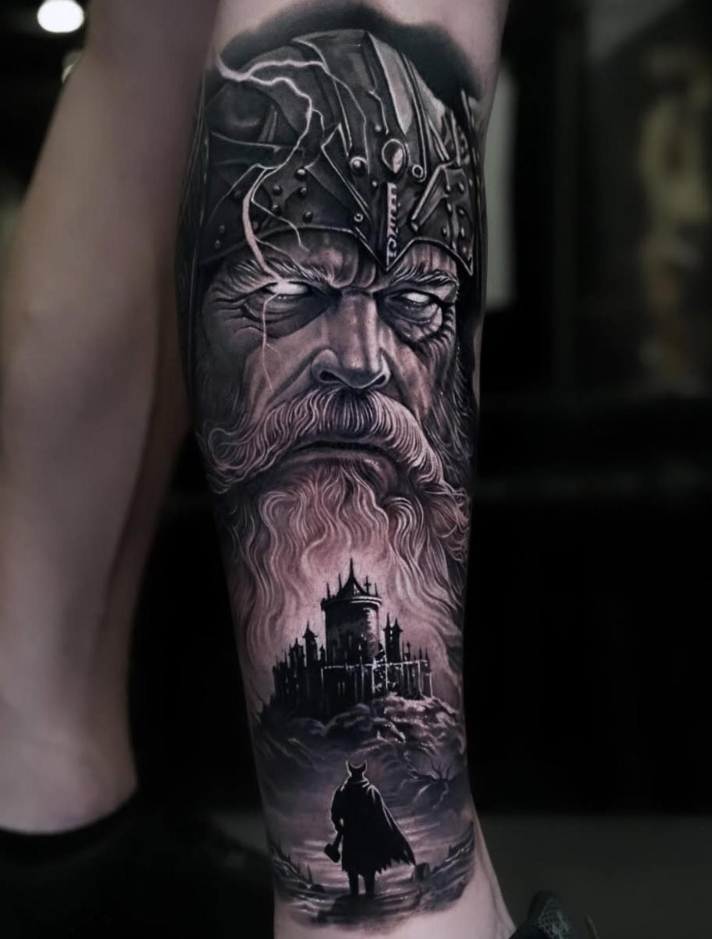 Black and grey realistic Viking portrait and castle tattoo on calf
