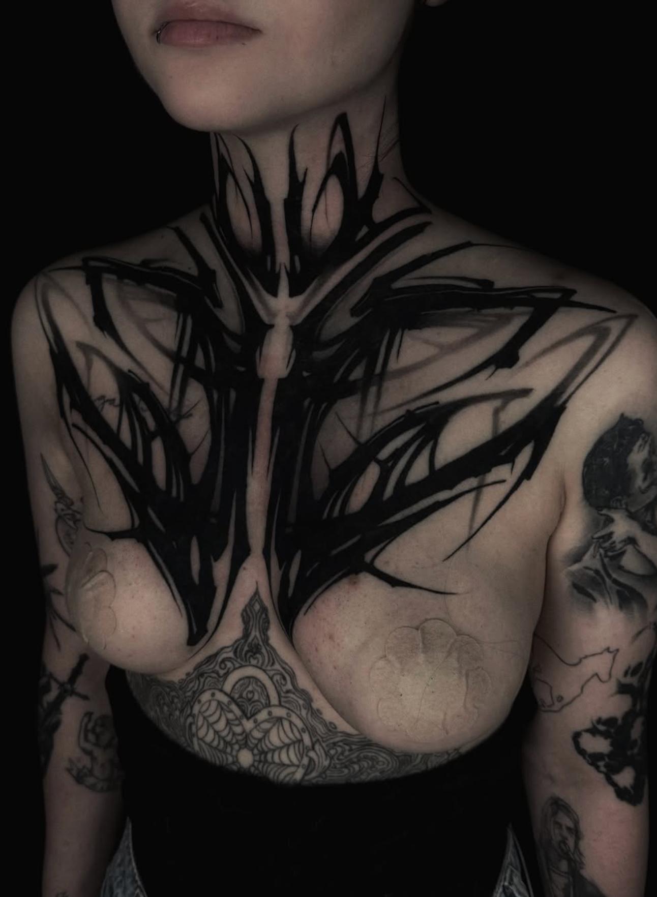 Abstract blackwork design covering the chest and neck