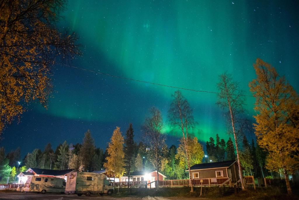 Northern lights above the cottages in autumn