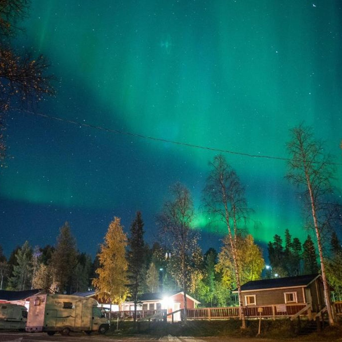 Northern lights above the cottages in autumn