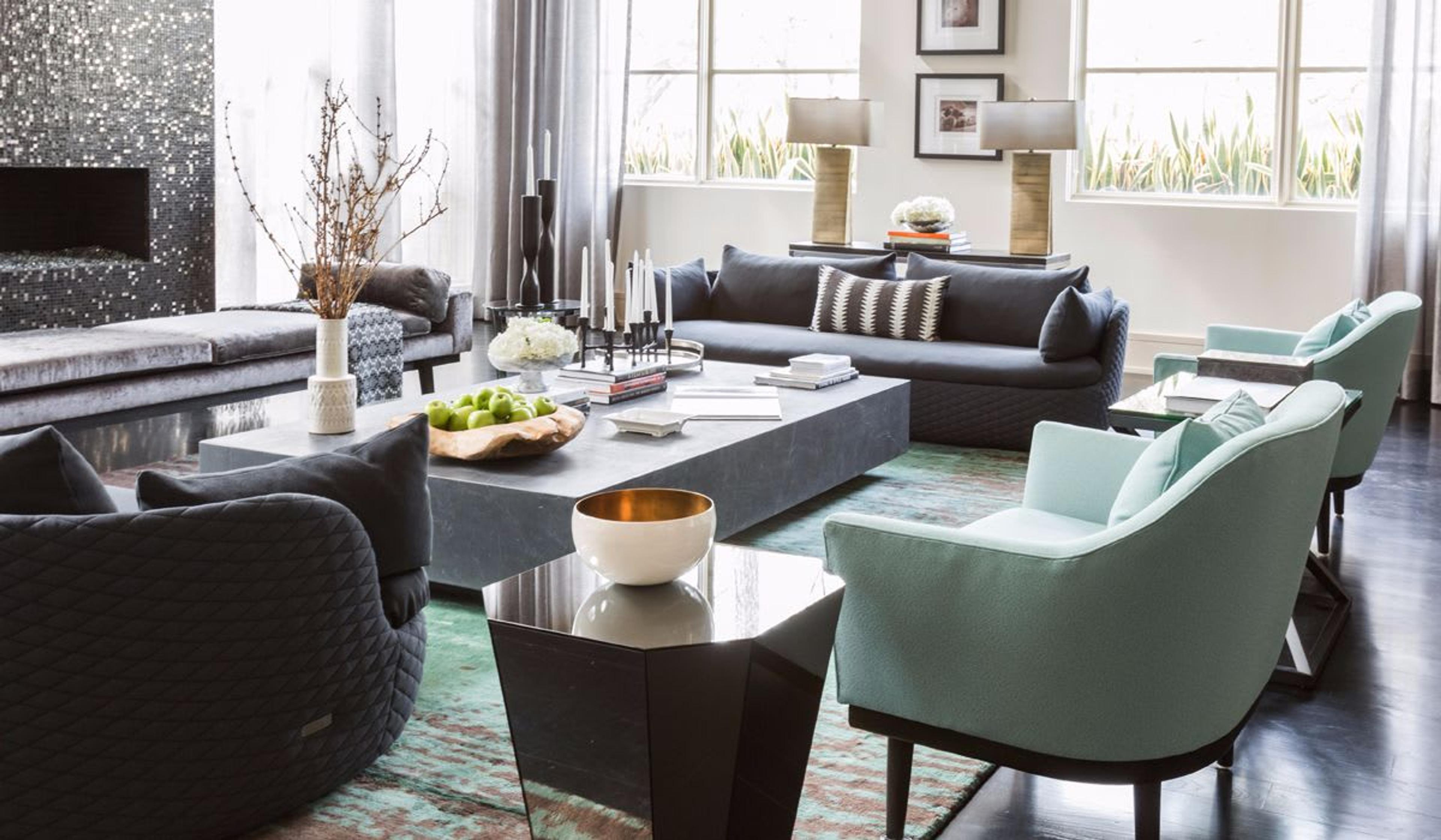 The  family room features an array of custom pieces curated by Nina Magon. Twin Moooi Sofas are accented by a bench recovered in Brentano fabric from Donghia and side chairs recovered in ArcCom Fabric. 