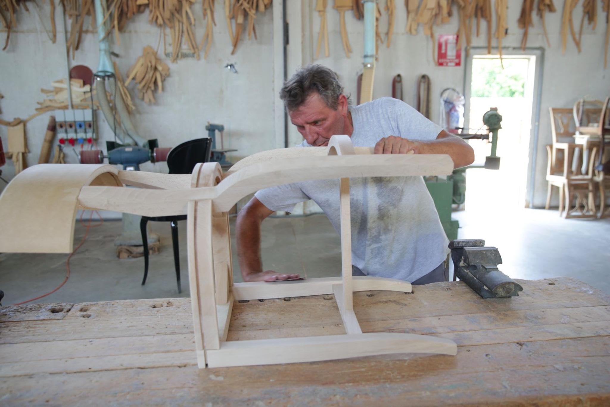 An artisan at work on a chair