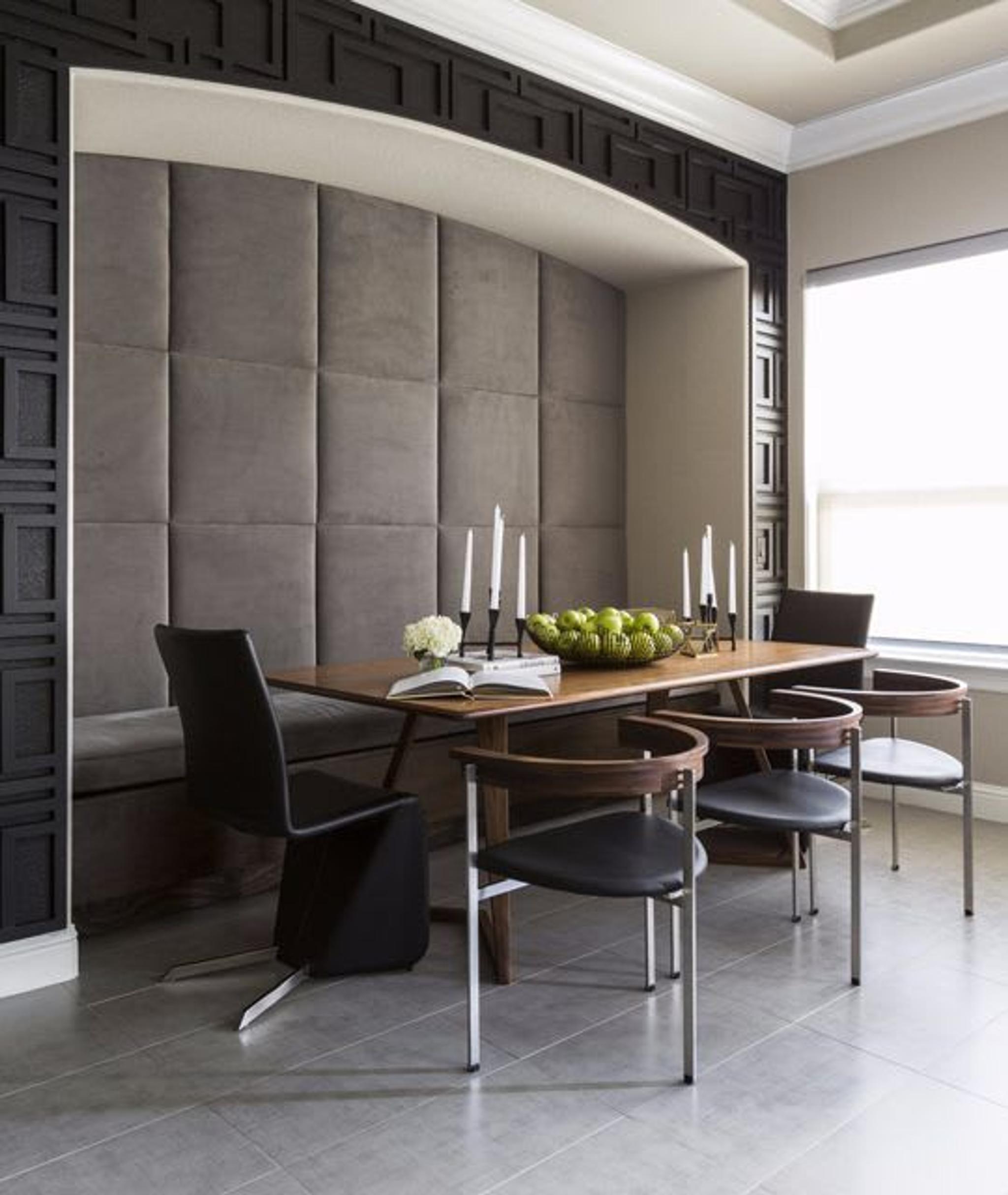 For the breakfast niche of this Sugar Land residence, Nina created a  custom-stained wood design that was carefully built piece by piece while the inside of the niche is covered in grey tufting. 