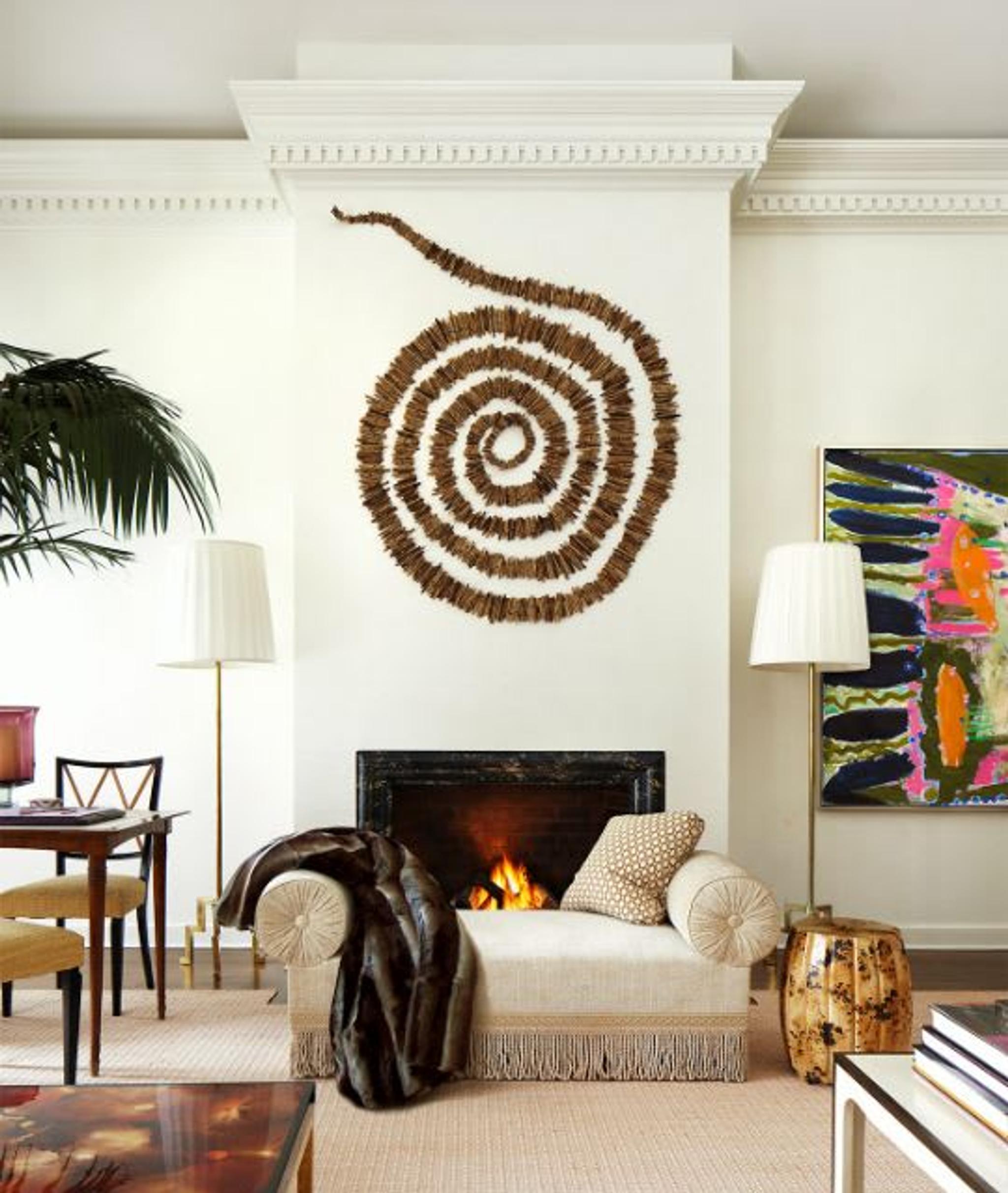 Vintage Italian games table and chairs are sheltered by a large palm.  Victorian inspired bench provides a social perch for conversation. Artwork is dramatic, featuring a local artist’s site installation of river reads above the mantle.
