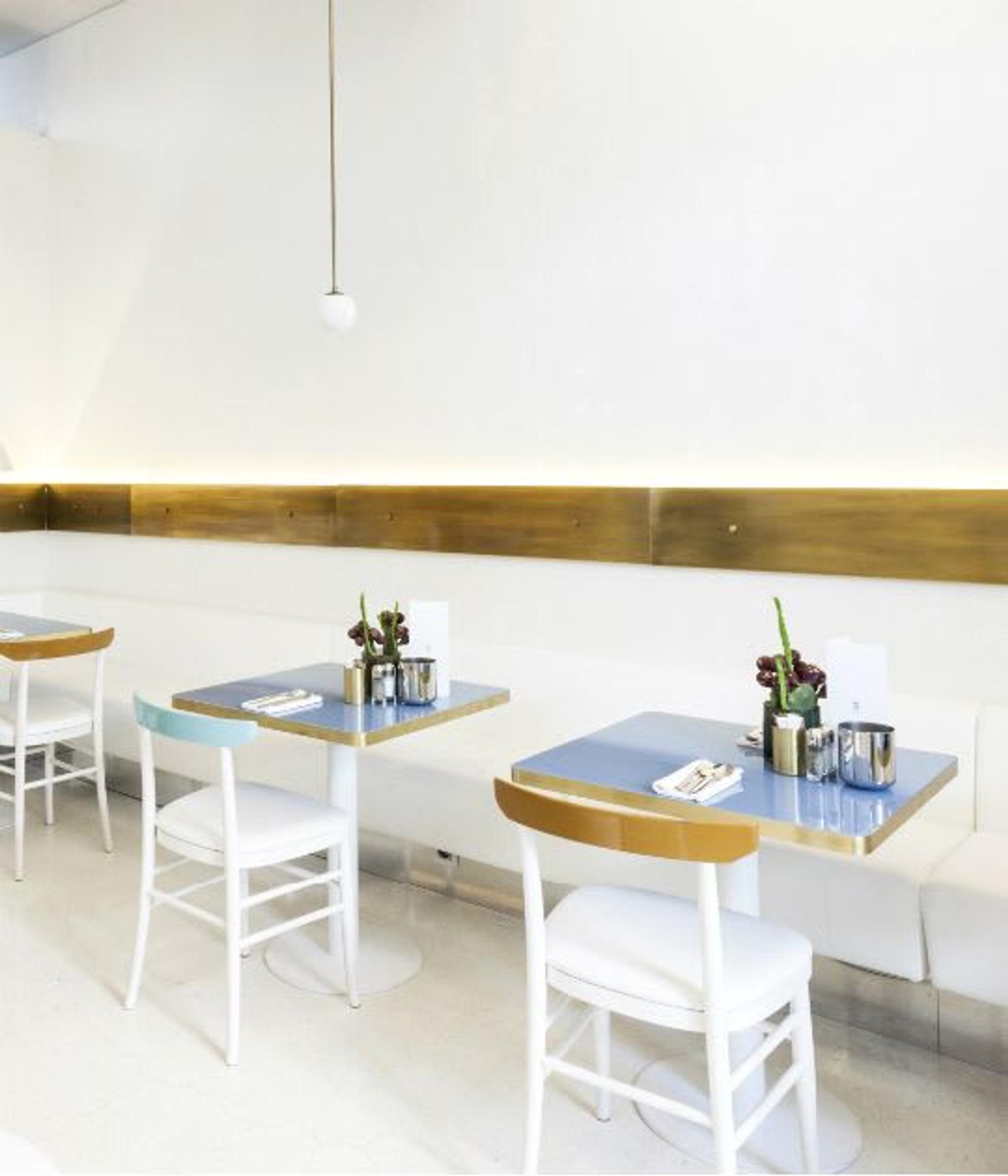 Brass details and baby blue marble tables at Senato Caffè.