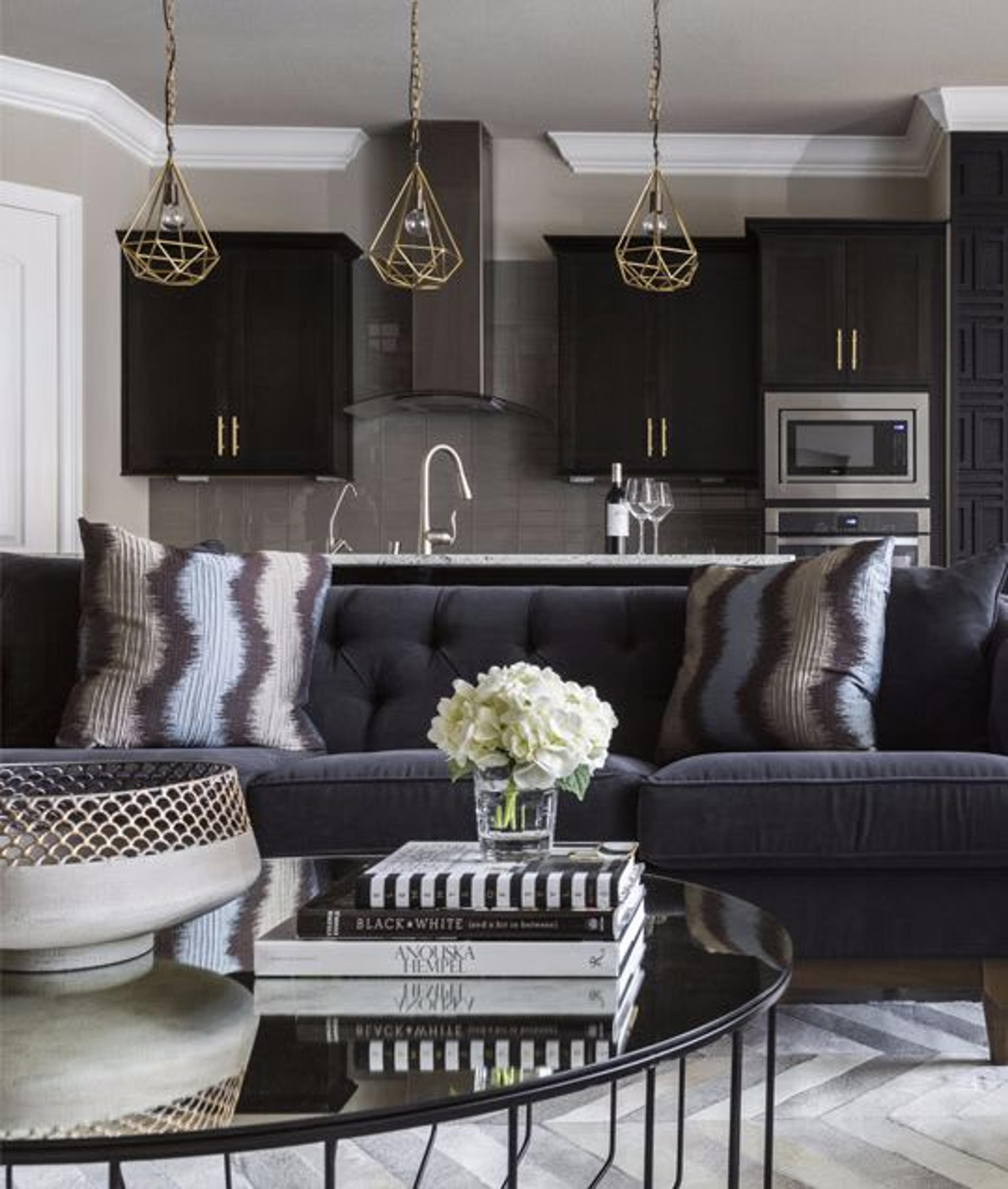 Gold accents were added to the black kitchen rather than stainless steel to create a color-rich palette that felt sophisticated yet welcoming.