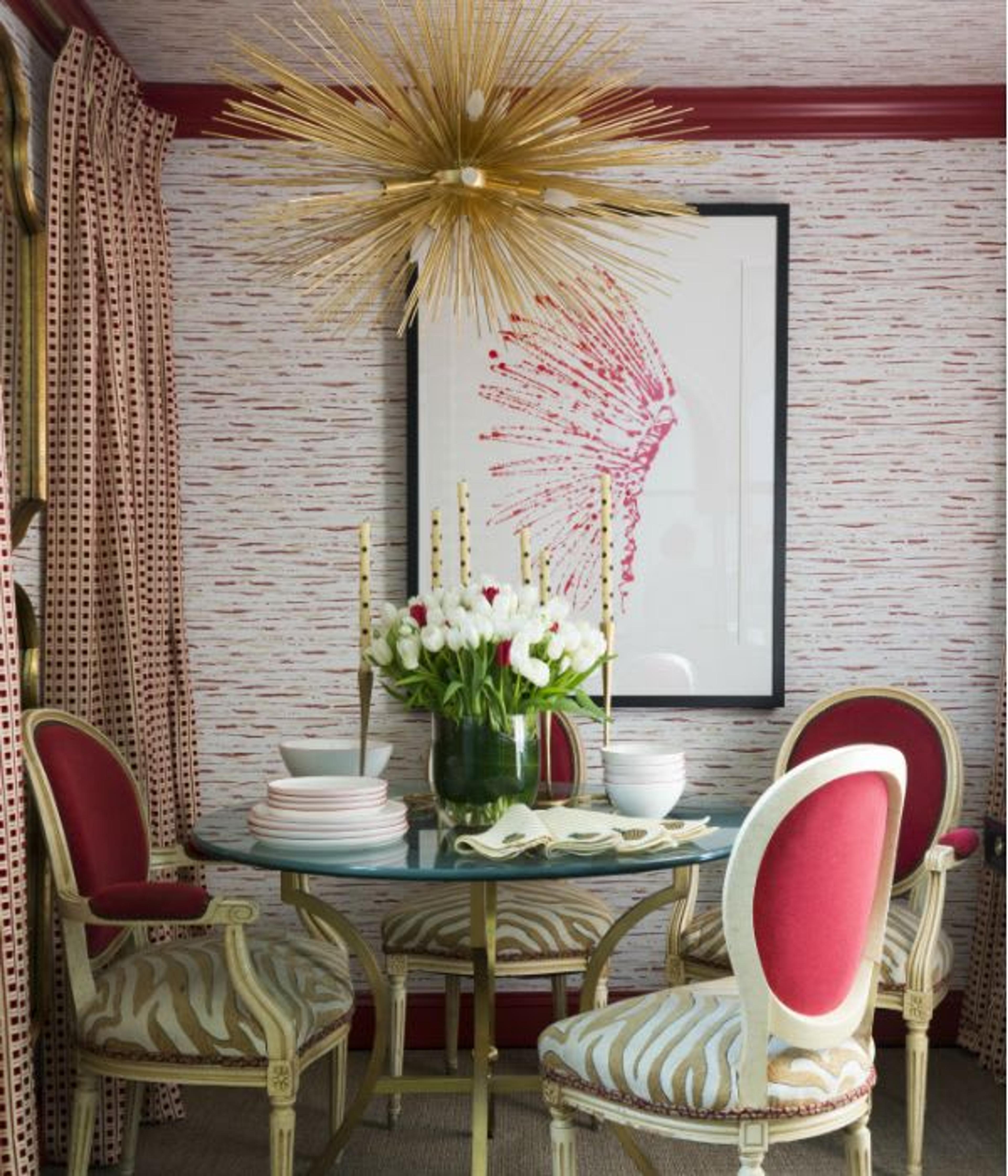 Dining area decor by The A List Jonathan Savage - pink accents, a splendid combination of patterns and the brass statement chandelier- make this a stunning dining area.