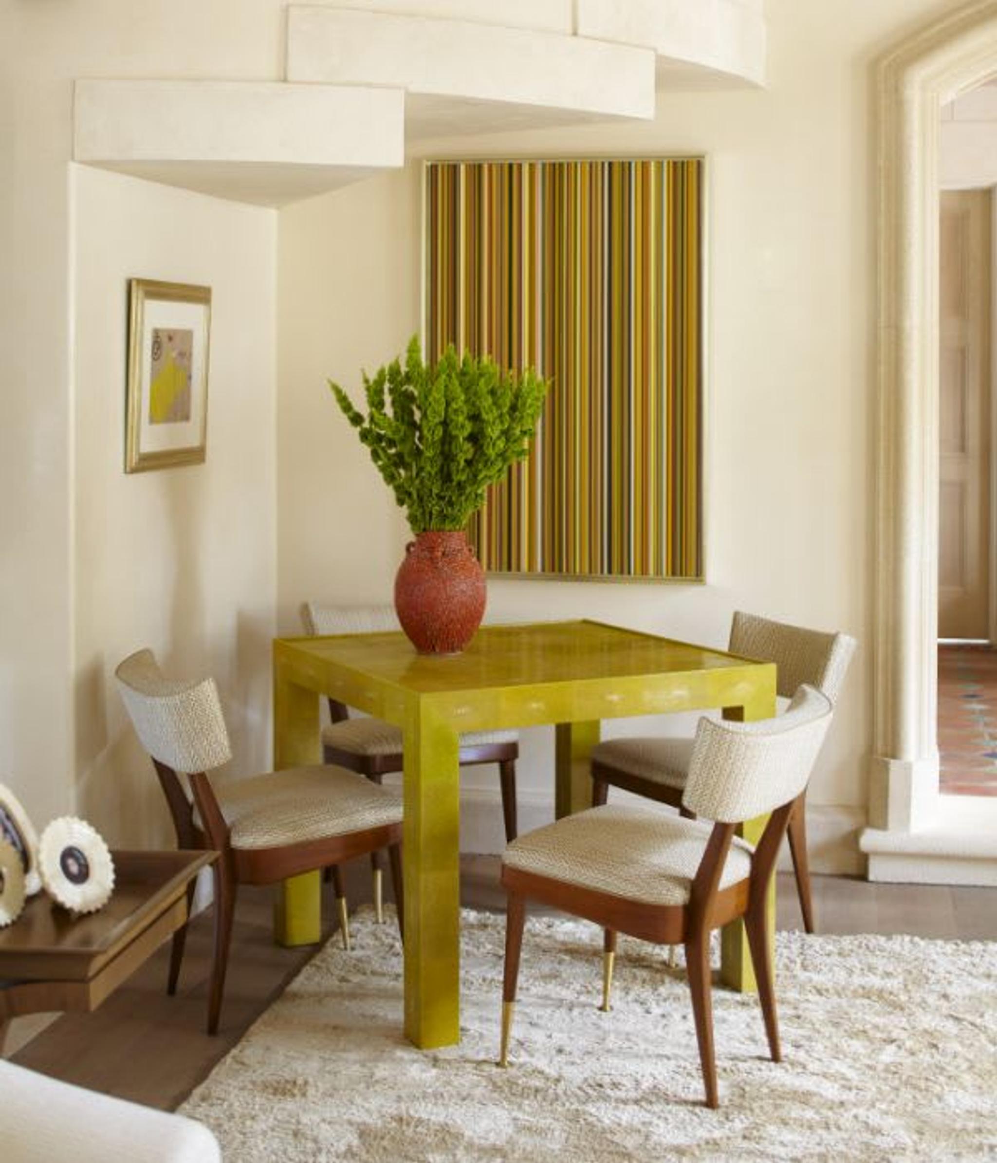 Yellow accents in a pretty sitting corner of this beautiful Palm Beach property decorated by ​Cullman & Kravis.