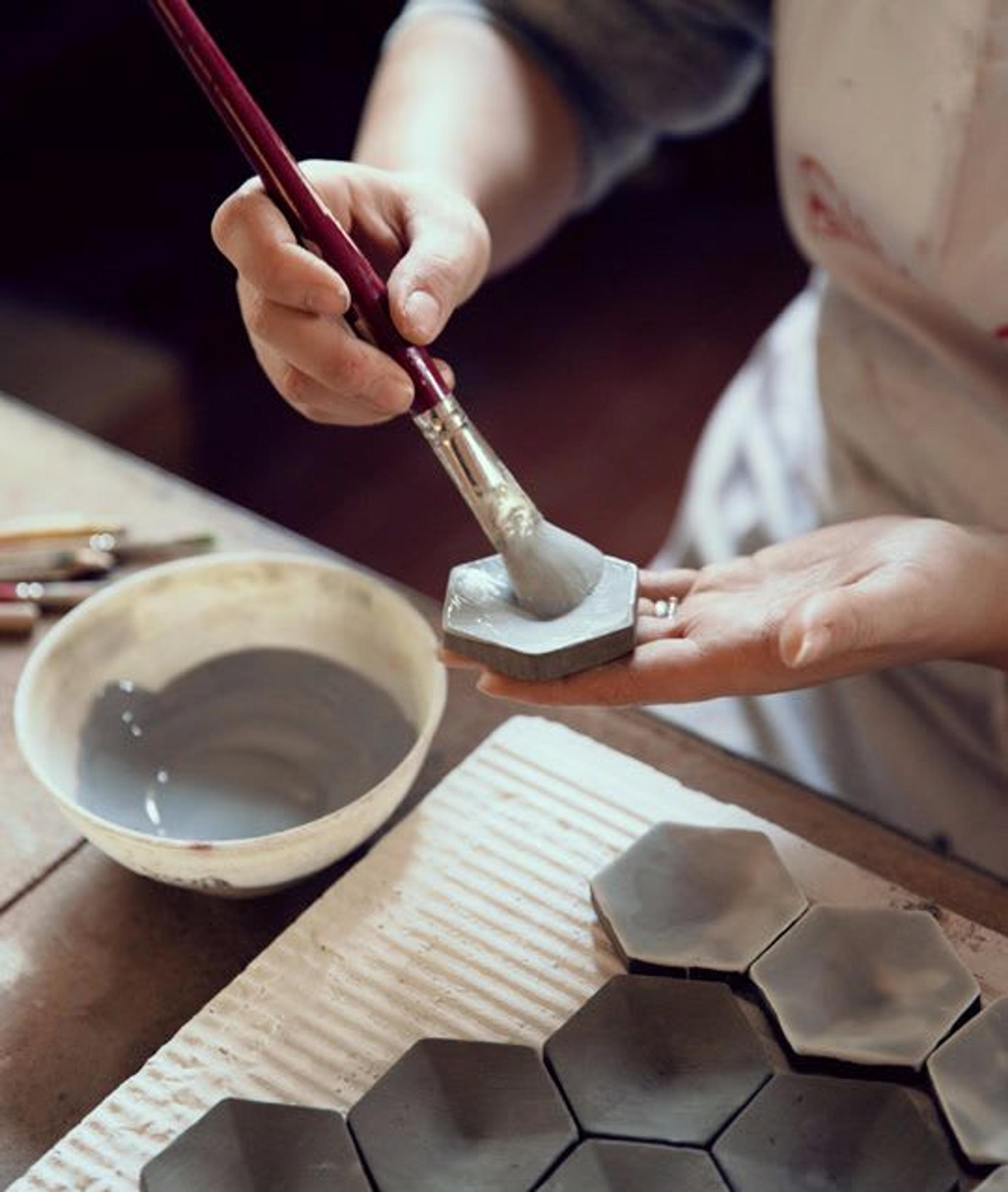 Hand painting ceramic mosaics in the ceramic workshop of BottegaNove