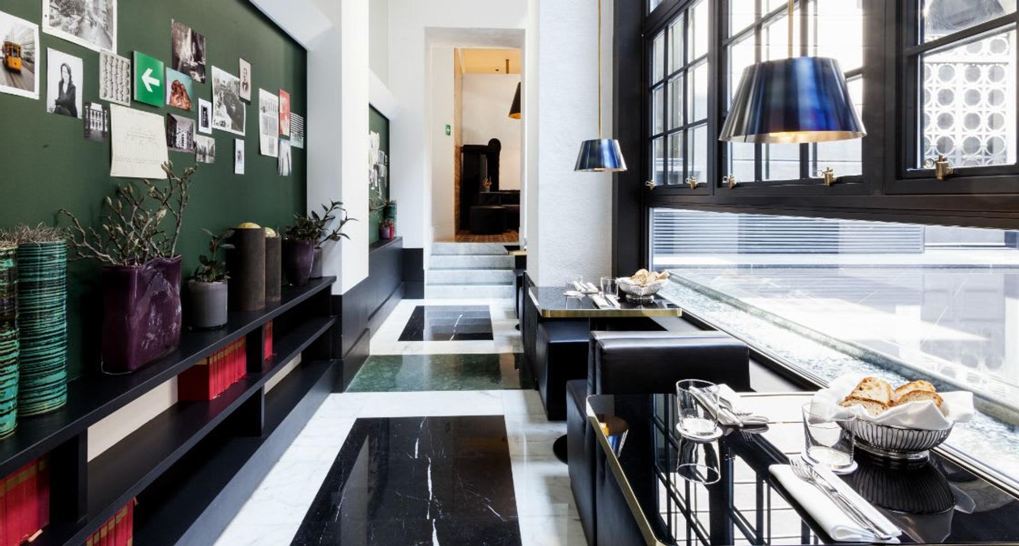 Senato Hotel bistrot featuring a mood board, a love letter to the city that coexists with a library stocked with literature classics.