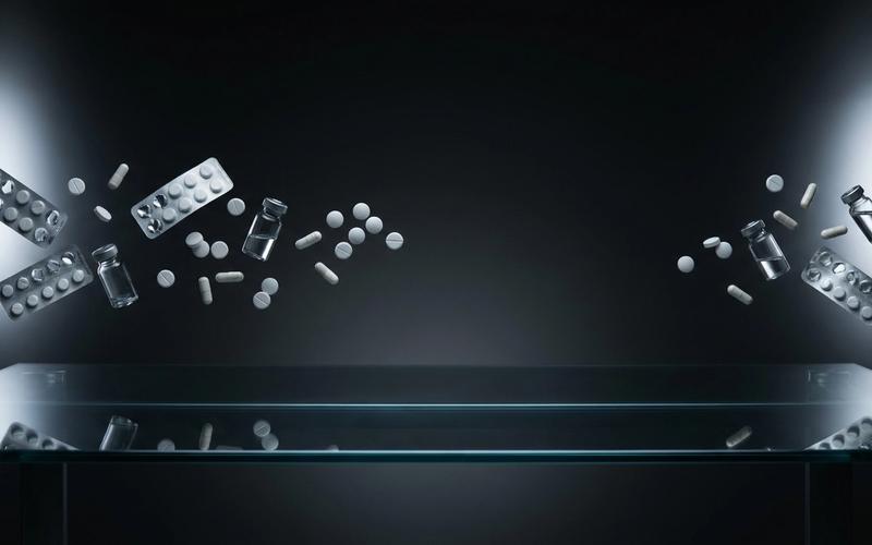 Dark editorial scene with floating medicine objects and cool studio lighting