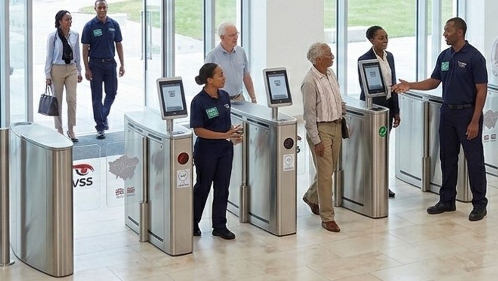 Security officers managing entry through the turnstiles at a venue entrance