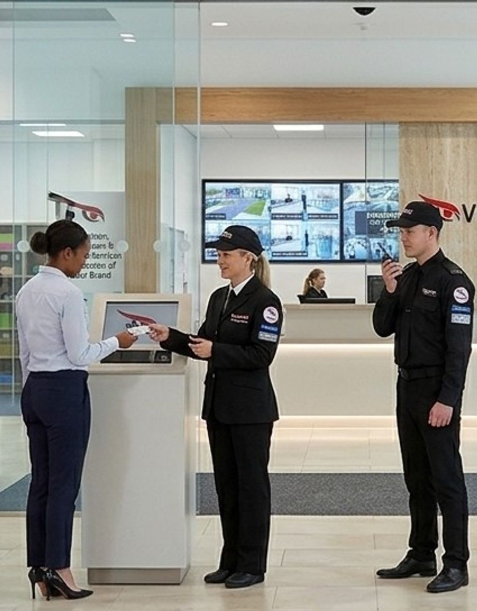 Door supervisor greeting a visitor at a venue reception desk
