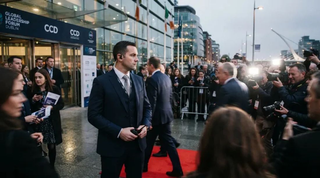 Suited security officer watching guest arrivals on the red carpet outside the Dublin Convention Centre