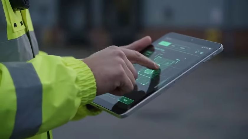 Officer in a high-visibility jacket completing a checklist on a tablet